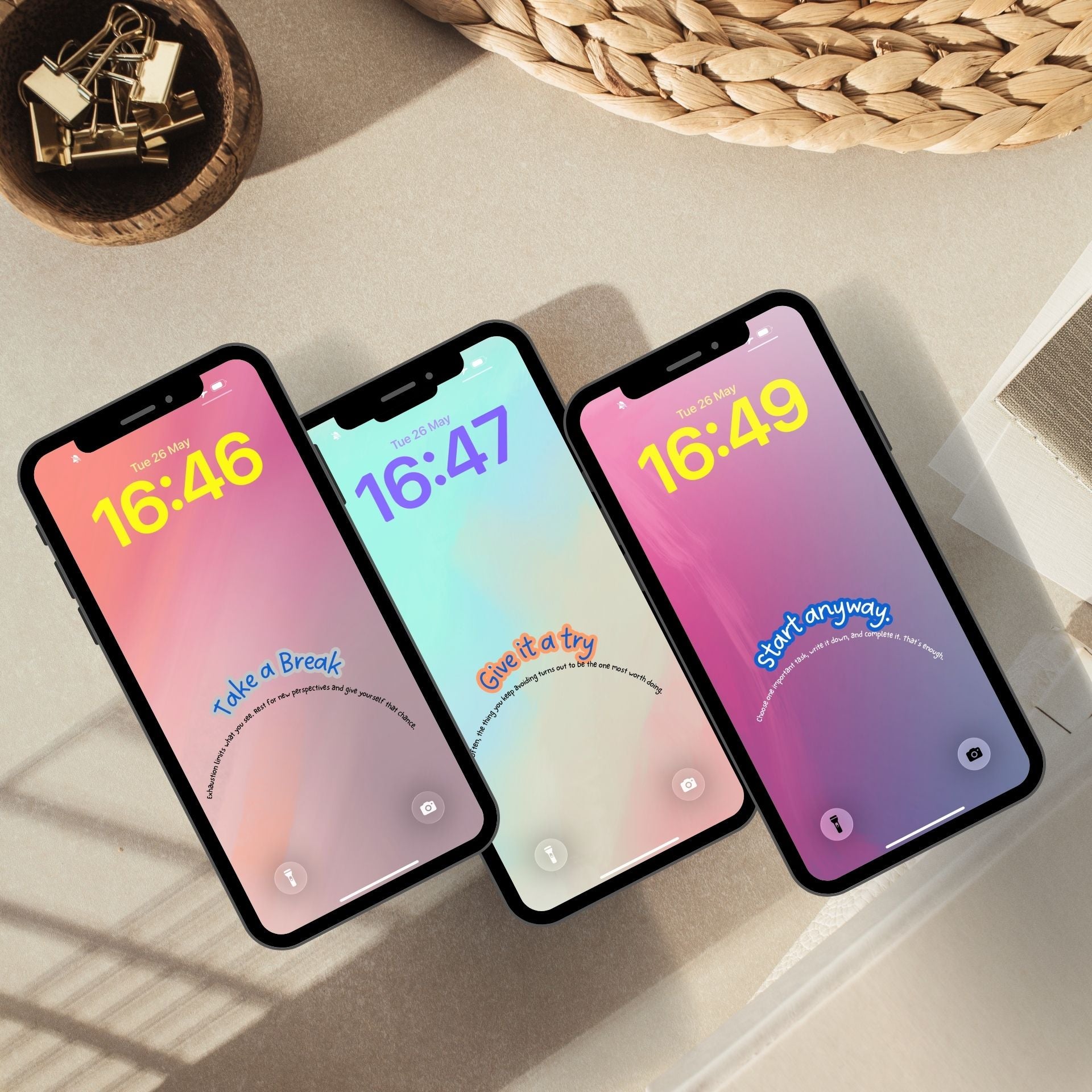 Three phone mockups layered at an angle showing soft pastel lock screen wallpapers. A short affirmation curves along the bottom of each screen in a gentle arch.