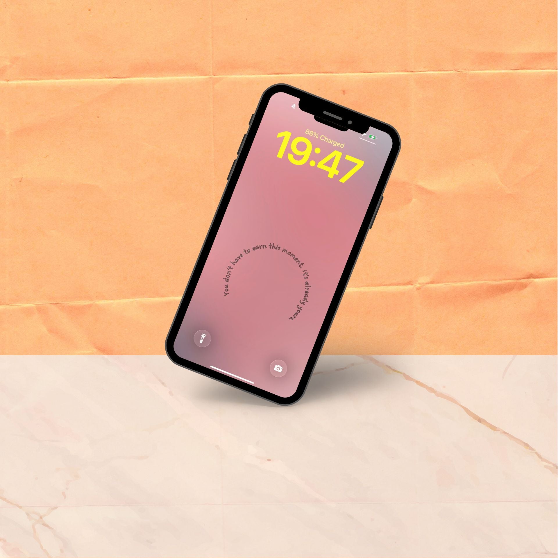 A single phone tilted at an angle showing a soft pink rose gradient wallpaper design with a short affirmation curving gently at the centre.